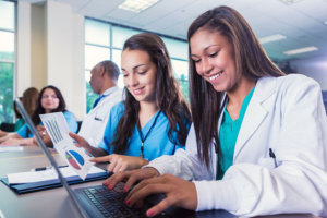 Two nursing students working on a laptop