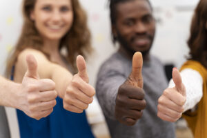 group of happy people with their thumbs up