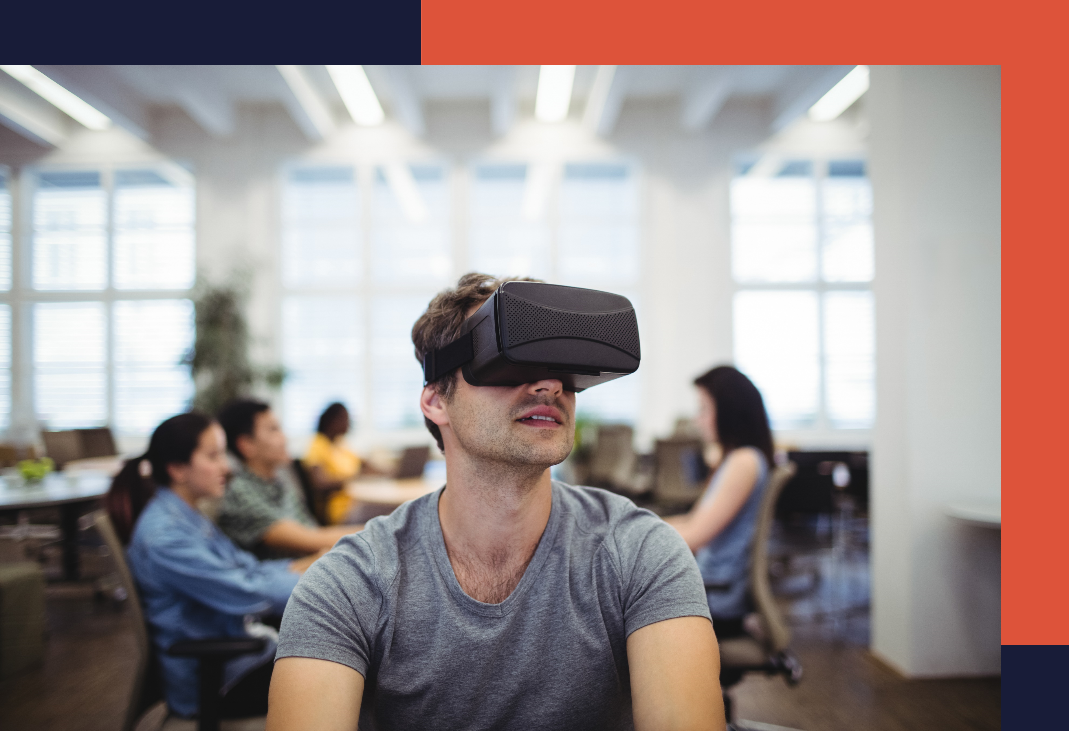 man looking through VR goggles while at work