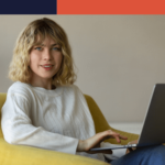 Side view of a woman working on a laptop