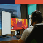 Man sitting at desk playing games on computer