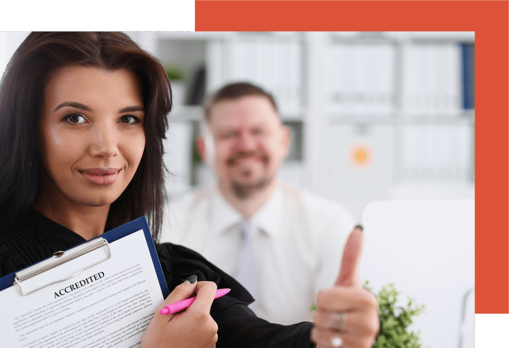 Business woman holding a file that says: Accreditation and giving a thumbs up.