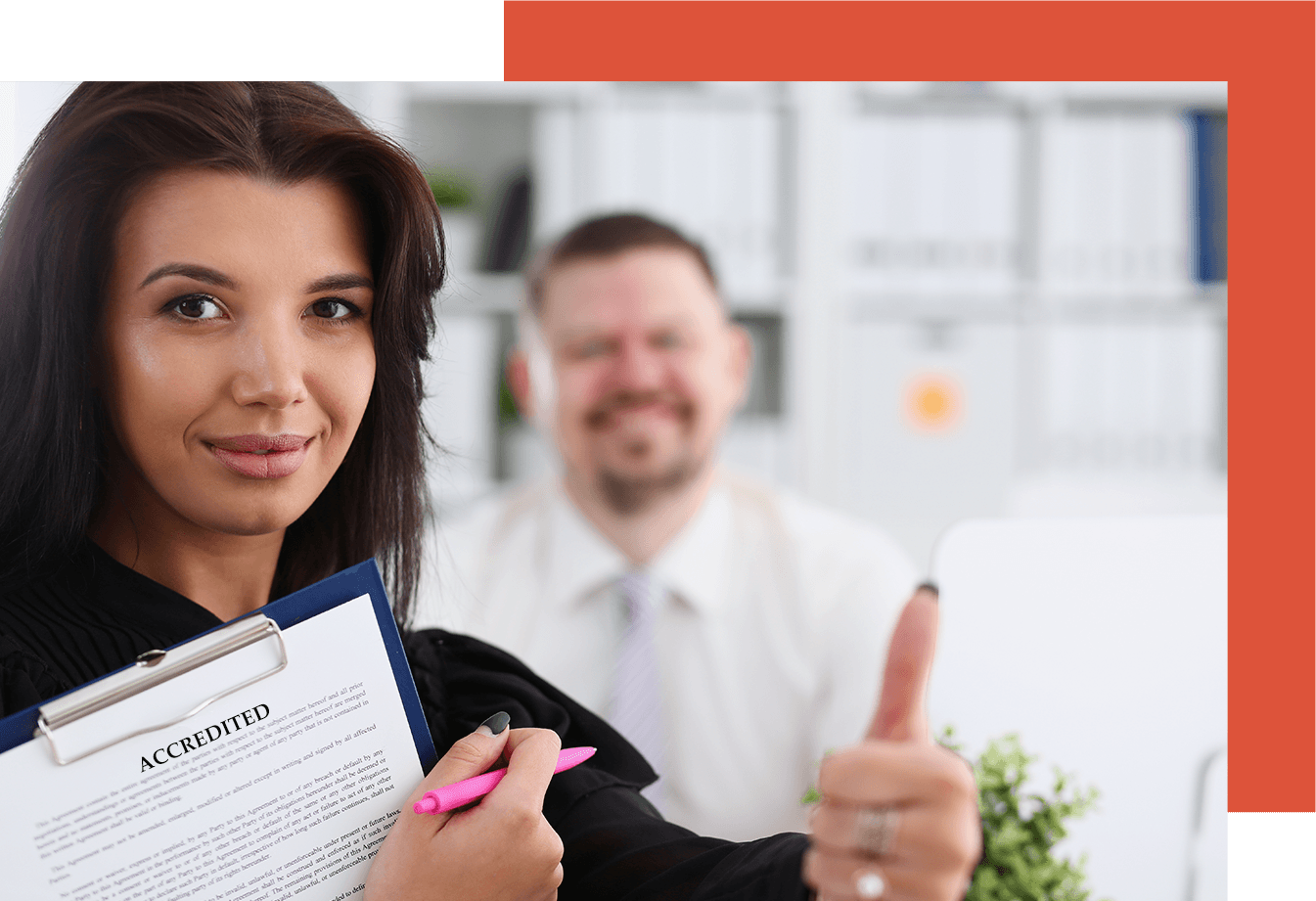 Business woman holding a file that says: Accreditation and giving a thumbs up.